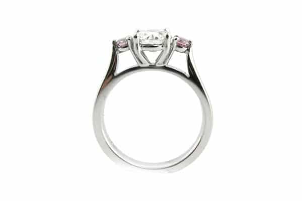 Round brilliant cut white and pink diamond three stone ring