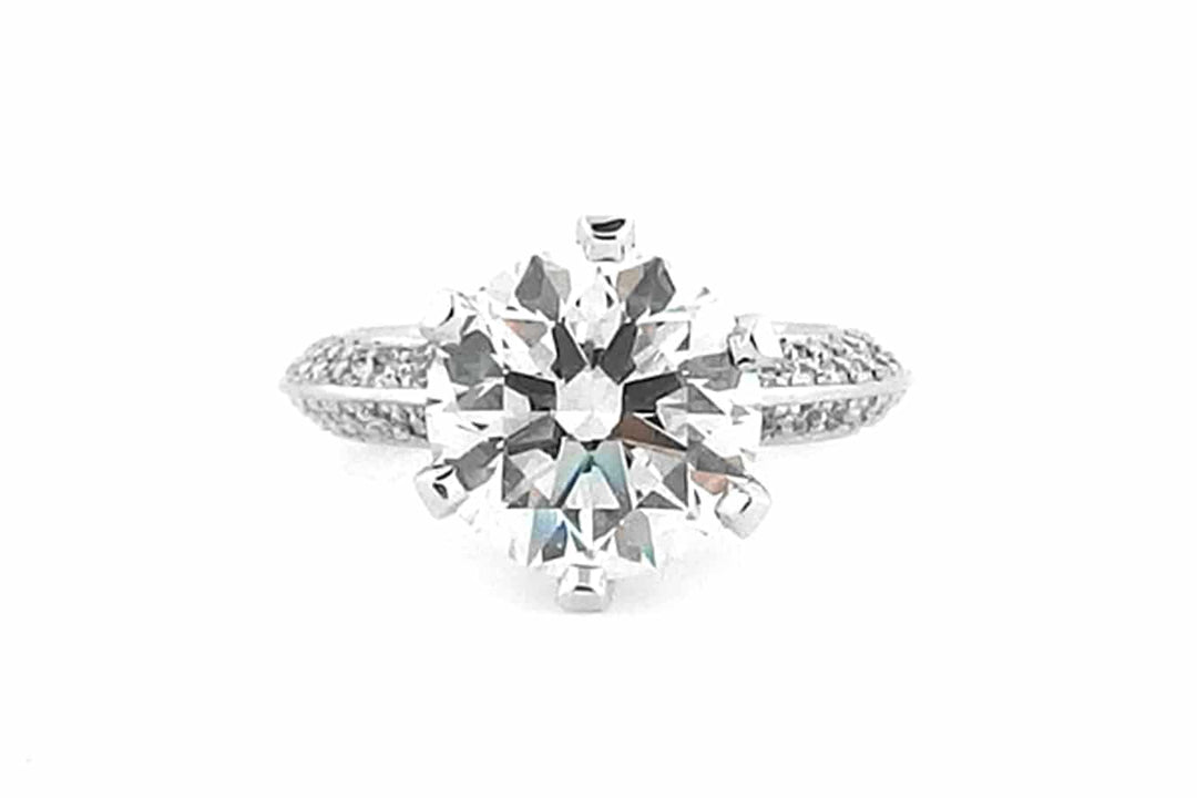 Round brilliant cut with diamonds on the band and setting