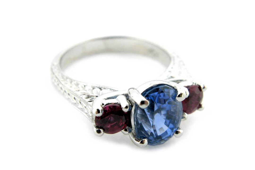 Ruby and sapphire three stone ring with engraving on the band