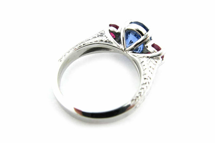 Ruby and sapphire three stone ring with engraving on the band