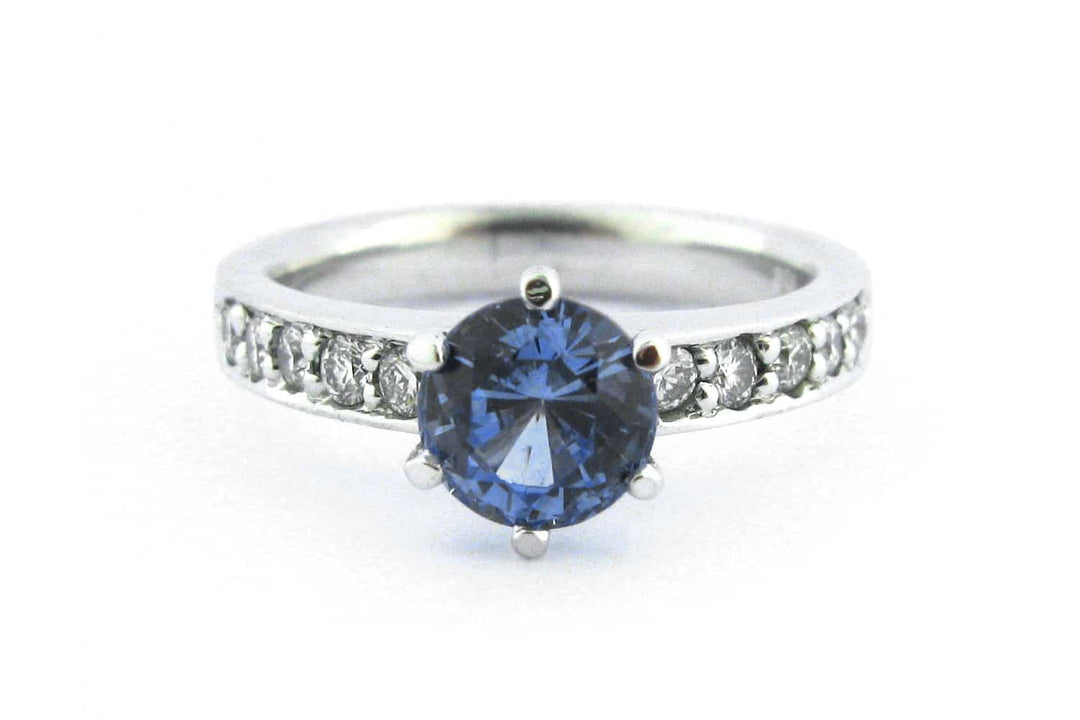 Six claw set blue sapphire ring with bead set diamonds