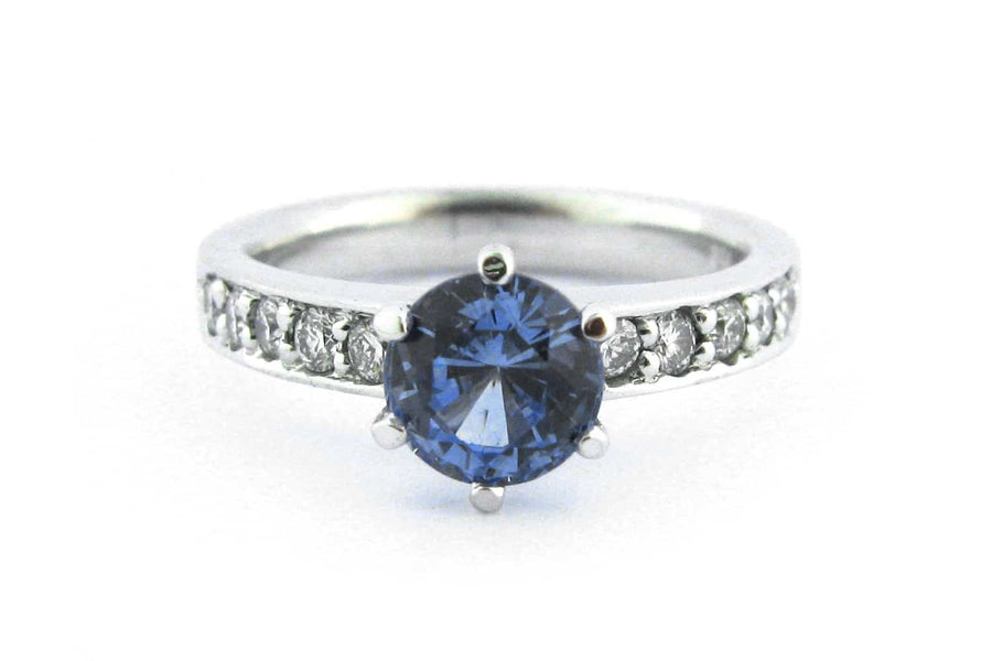 Six claw set blue sapphire ring with bead set diamonds