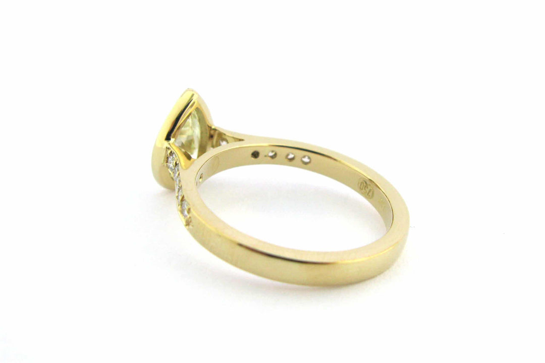 Bezel set pear shape diamond ring with bead set diamonds