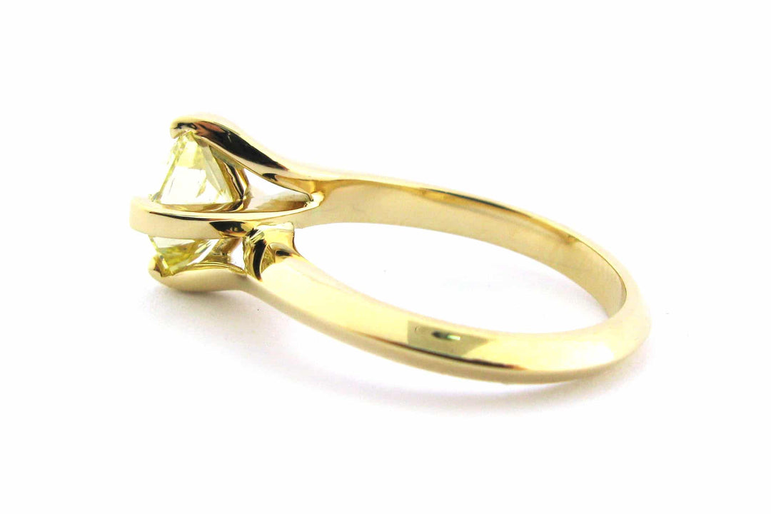 Fancy yellow diamond ring with a twisted band