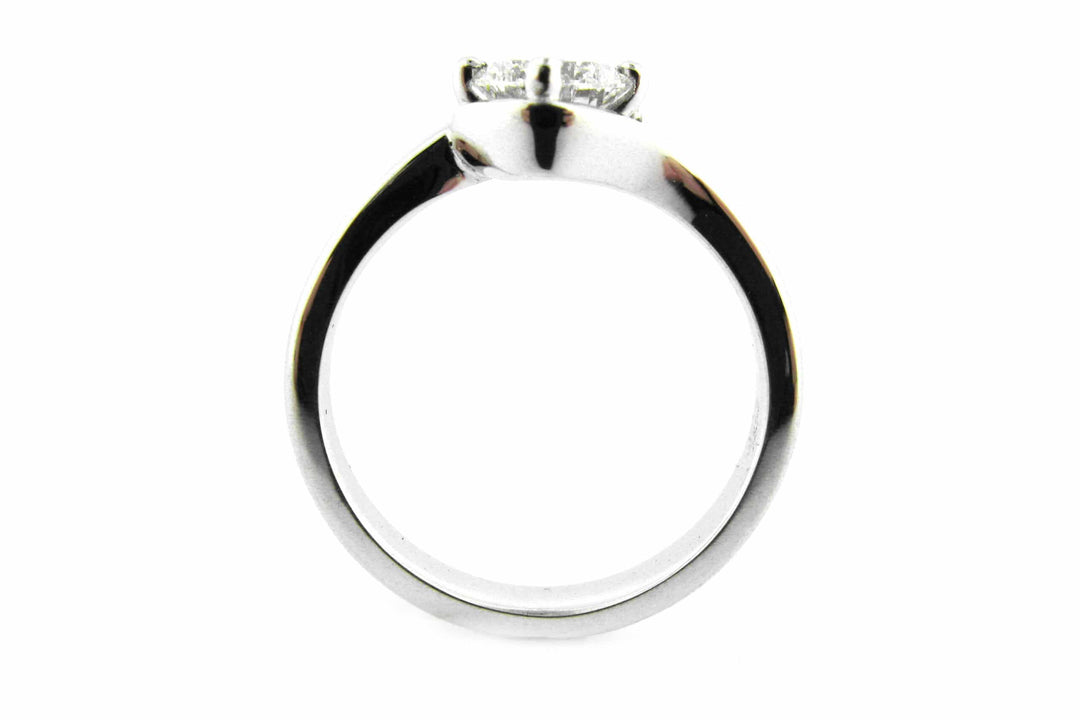 Twisted ring with a cushion cut diamond claw set