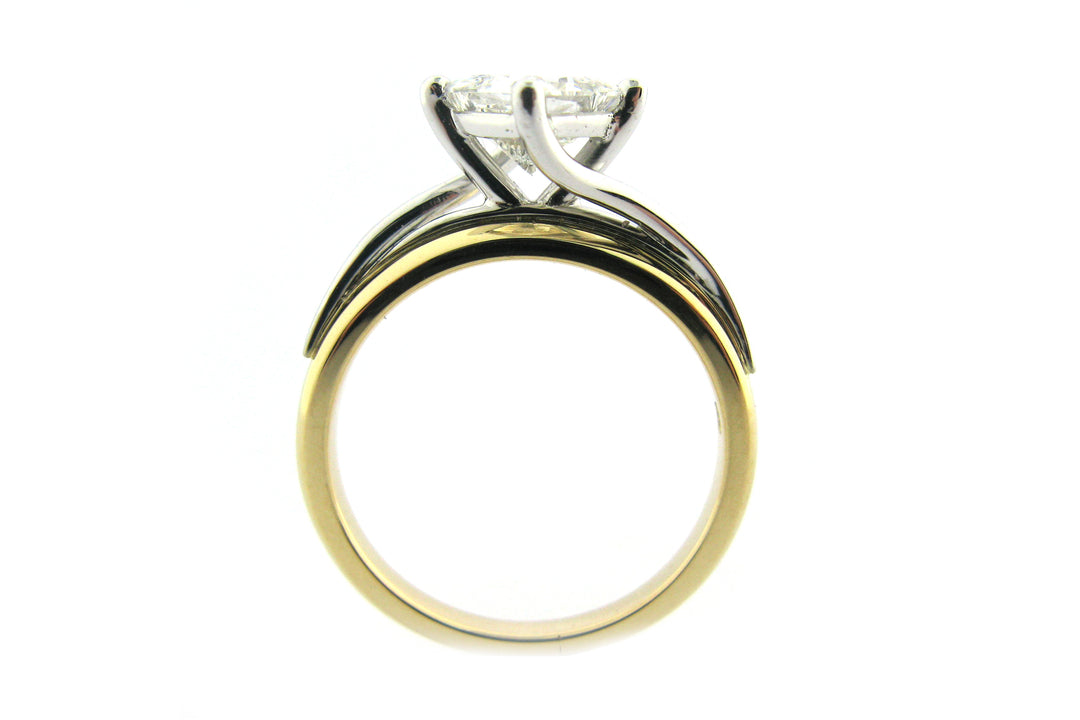 Two tone princess cut diamond ring set on the diagonal and a twisted band