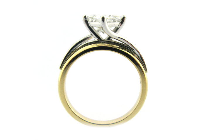 Two tone princess cut diamond ring set on the diagonal and a twisted band
