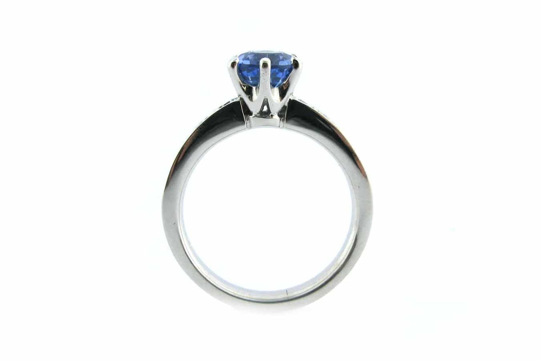 Six claw set blue sapphire ring with bead set diamonds