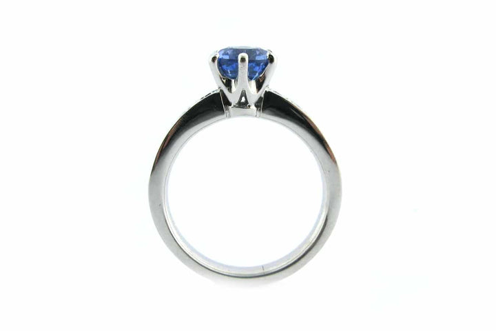 Six claw set blue sapphire ring with bead set diamonds