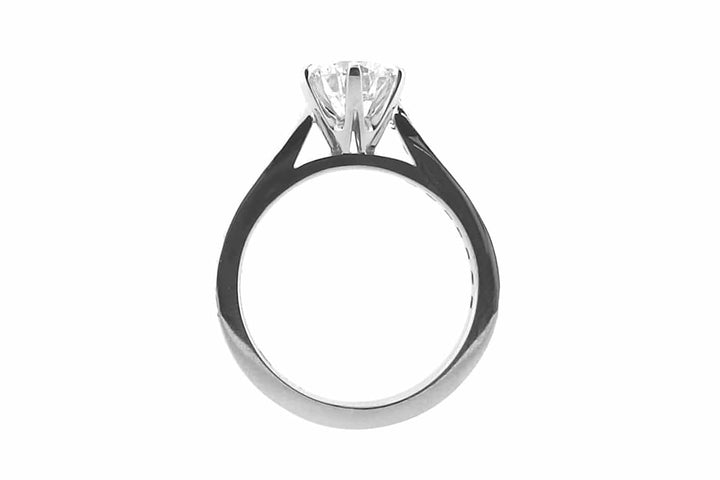 Six claw set round brilliant cut ring with bead set diamonds