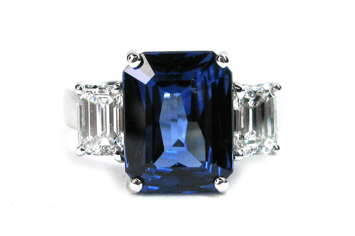 Three stone emerald cut sapphire and diamond ring