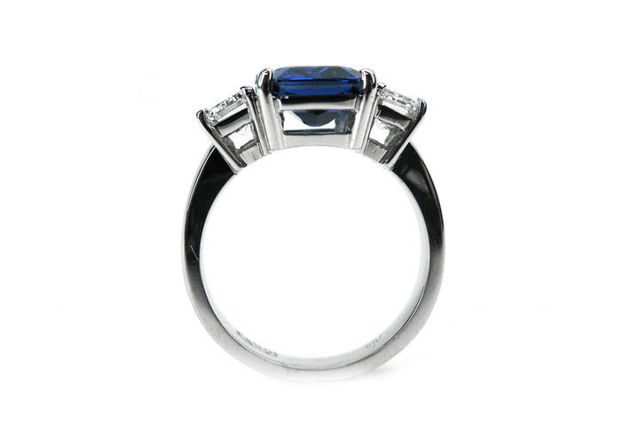 Three stone emerald cut sapphire and diamond ring