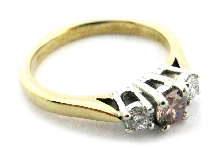 Three stone ring with pink and white round brilliant cut diamonds