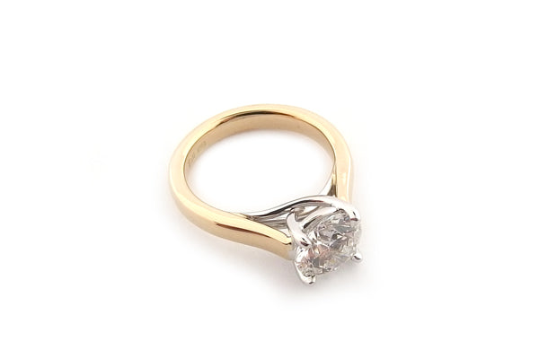 Yellow and white gold round brilliant cut cross over ring