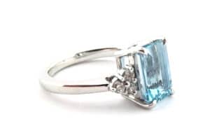 emerald cut aquamarine white gold ring with claw set diamonds
