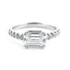 Emerald cut diamond talon set on white gold engagement ring with row of diamonds