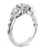 Three stone diamond engagement ring with talon set diamond and twisted white gold band