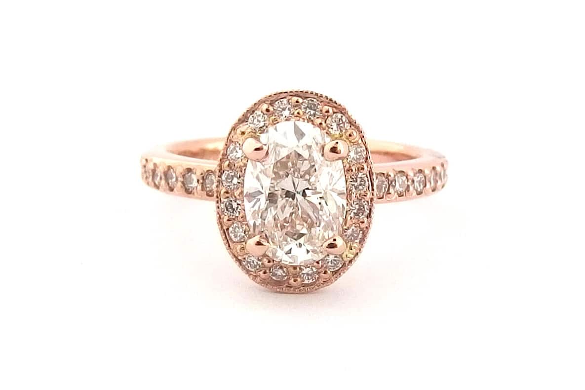 18ct rose gold halo ring with an oval diamond