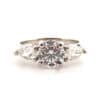 Three stone white gold engagement ring with round brilliant cut diamond and pear shape diamonds