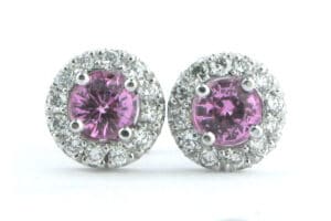 Pink sapphire earrings with a halo of round brilliant cut diamonds