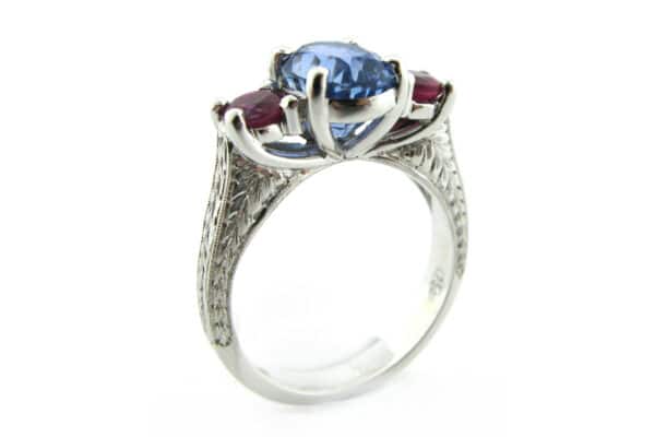 Ruby and sapphire three stone ring with engraving on the band