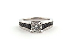 Black diamonds running the band of the engagement ring