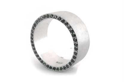 Wedding band with black diamonds surroundng the curve.